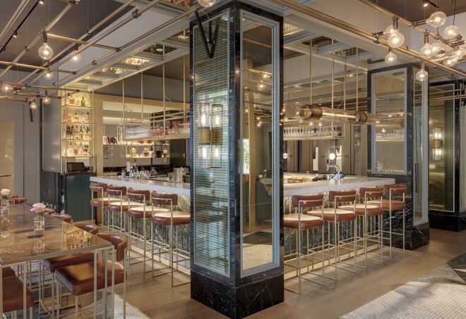 The interior of the Juliet Rose bar decorated with globe lights and mirrored pillars at Hilton Munich City, Germany.