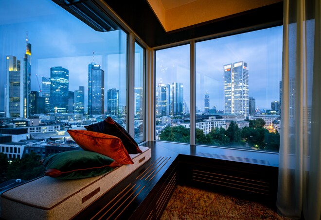 A view at dusk of Frankfurt’s banking district from large windows inside Hilton Frankfurt City Centre room.