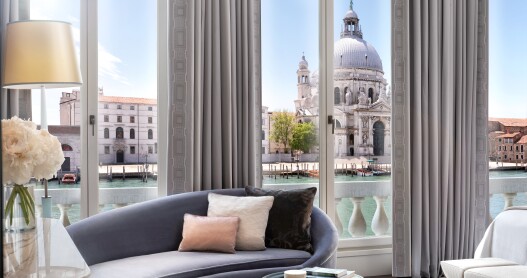 This guest room at the St. Regis Venice features a chaise longue and a balcony with views of the Grand Canal.