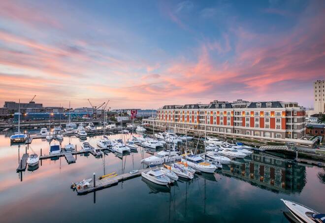 Cape Grace, A Fairmont Managed Hotel, sits on Cape Town's charming waterfront and has a red exterior.